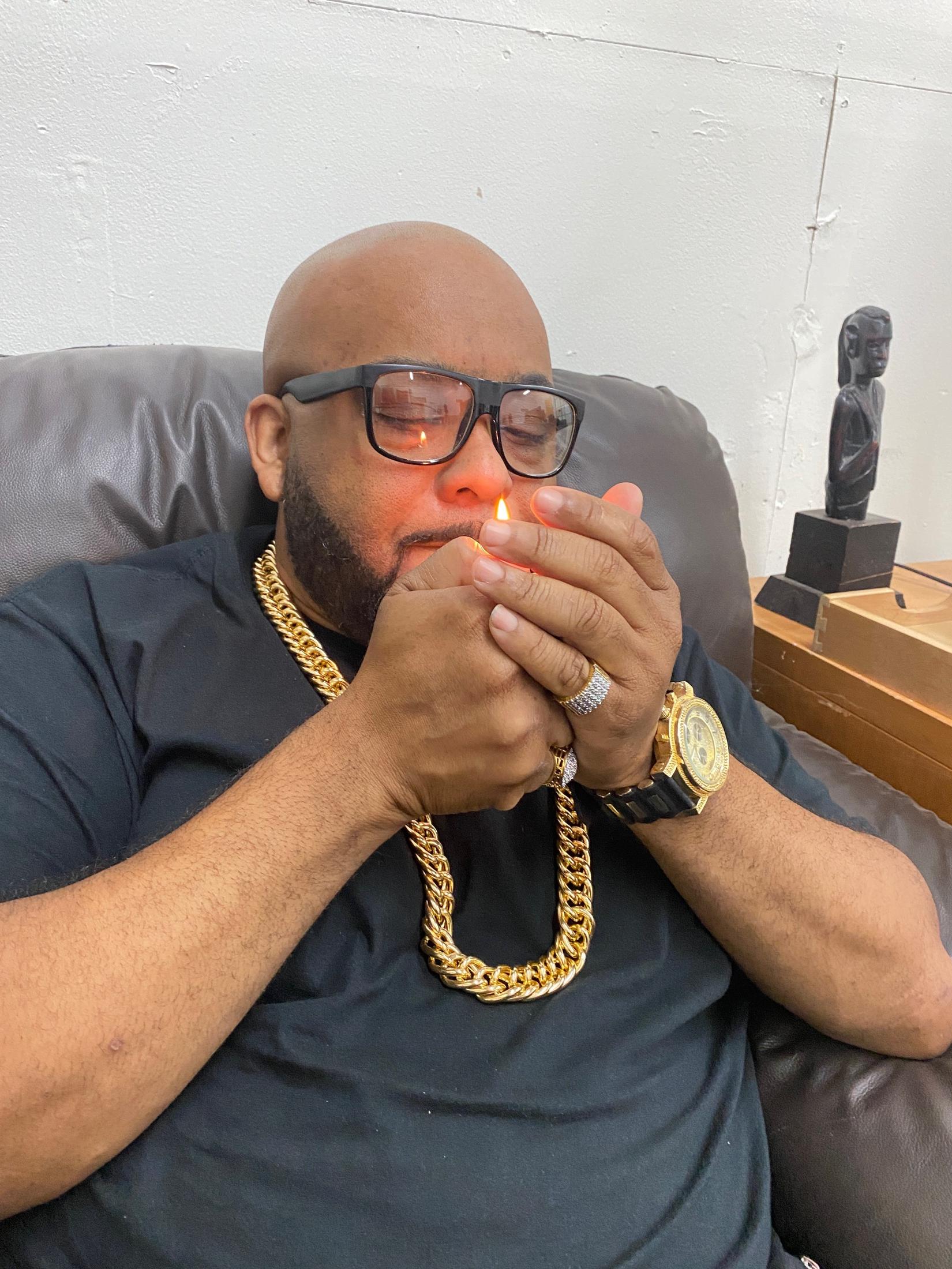 Boogie Taylor lighting a cigar